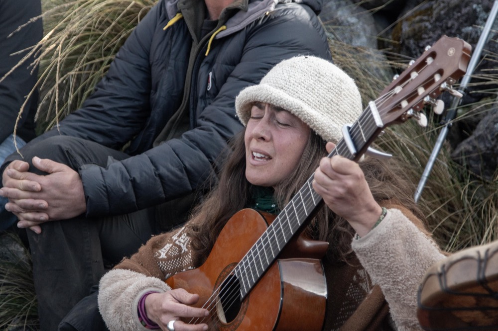 Helen singing in ceremony around the fire, Andes