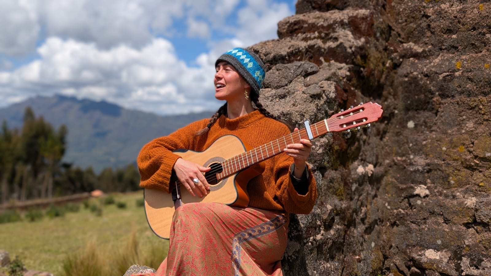 Helen playing guitar at Inca ruins, Sacred Valley, Peru